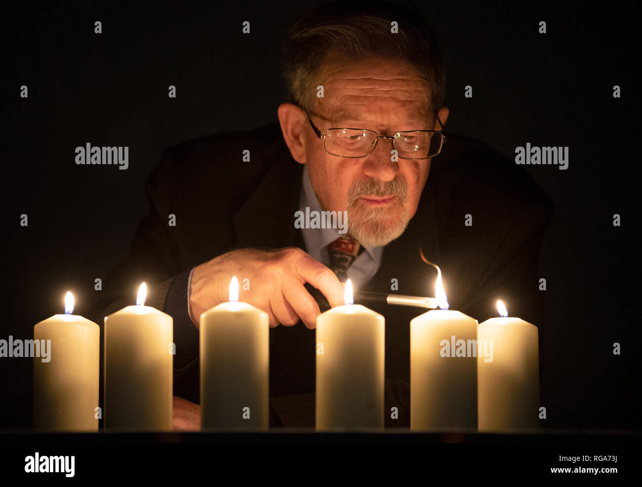 Holocaust survivor Martin Stern lights candles to mark National Holocaust Memorial Day ahead of a Holocaust and genocide survivors event at the Eastwood Park Theatre in Giffnock, East Renfrewshire. Stock Photo