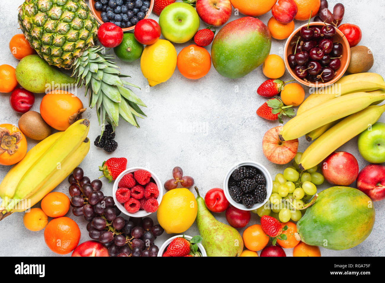 Rainbow fruits background frame, strawberries raspberries oranges plums ...