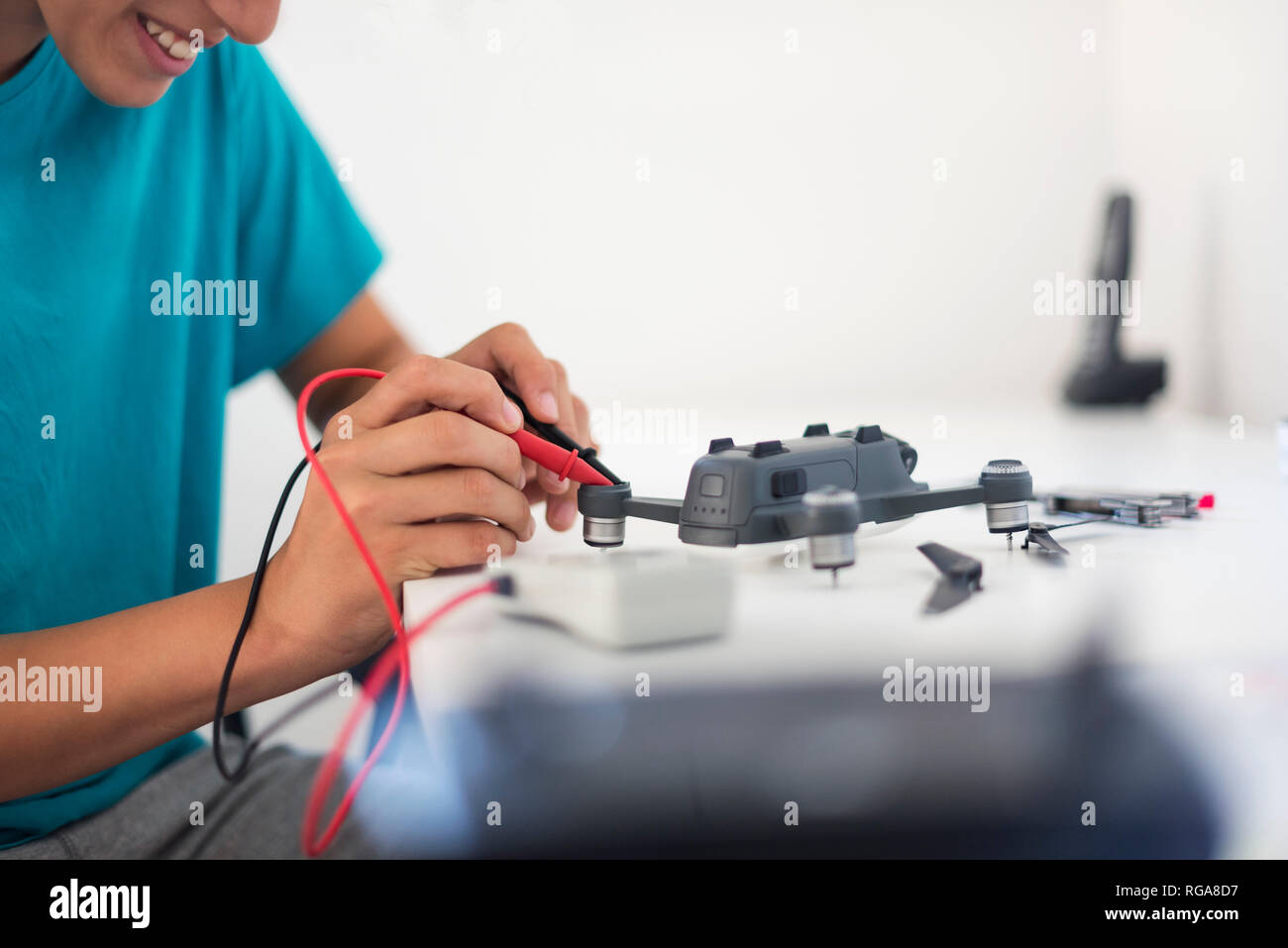 Boy repairing drone Stock Photo