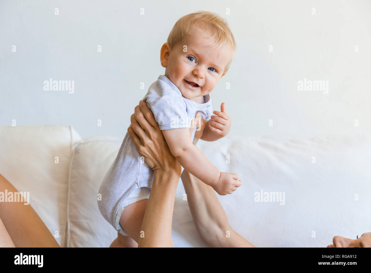 Portrait of happy baby girl held by her mother Stock Photo