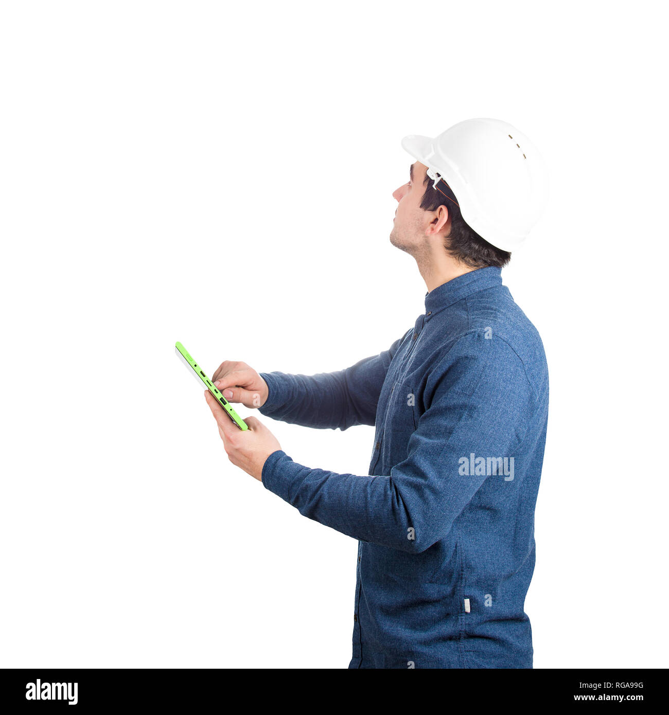 Serious confident young man engineer wearing protective helmet holding ...