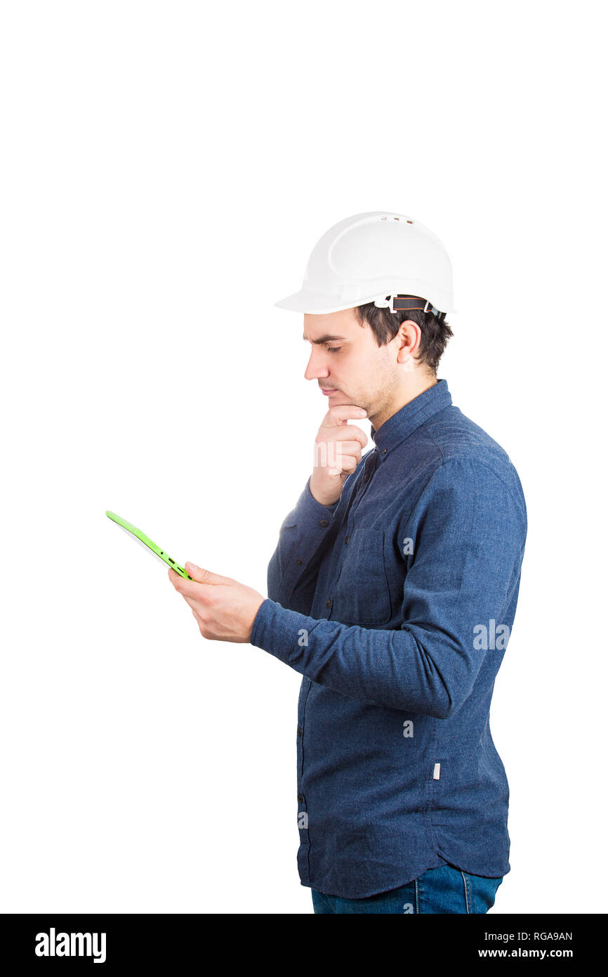 Side view thoughtful of young man engineer wearing protective helmet ...