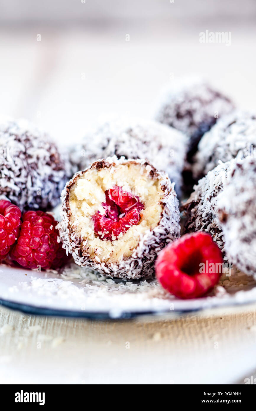 Lamington bliss balls with cashews, filled with raspberries, dark chocolate and coconut flakes Stock Photo