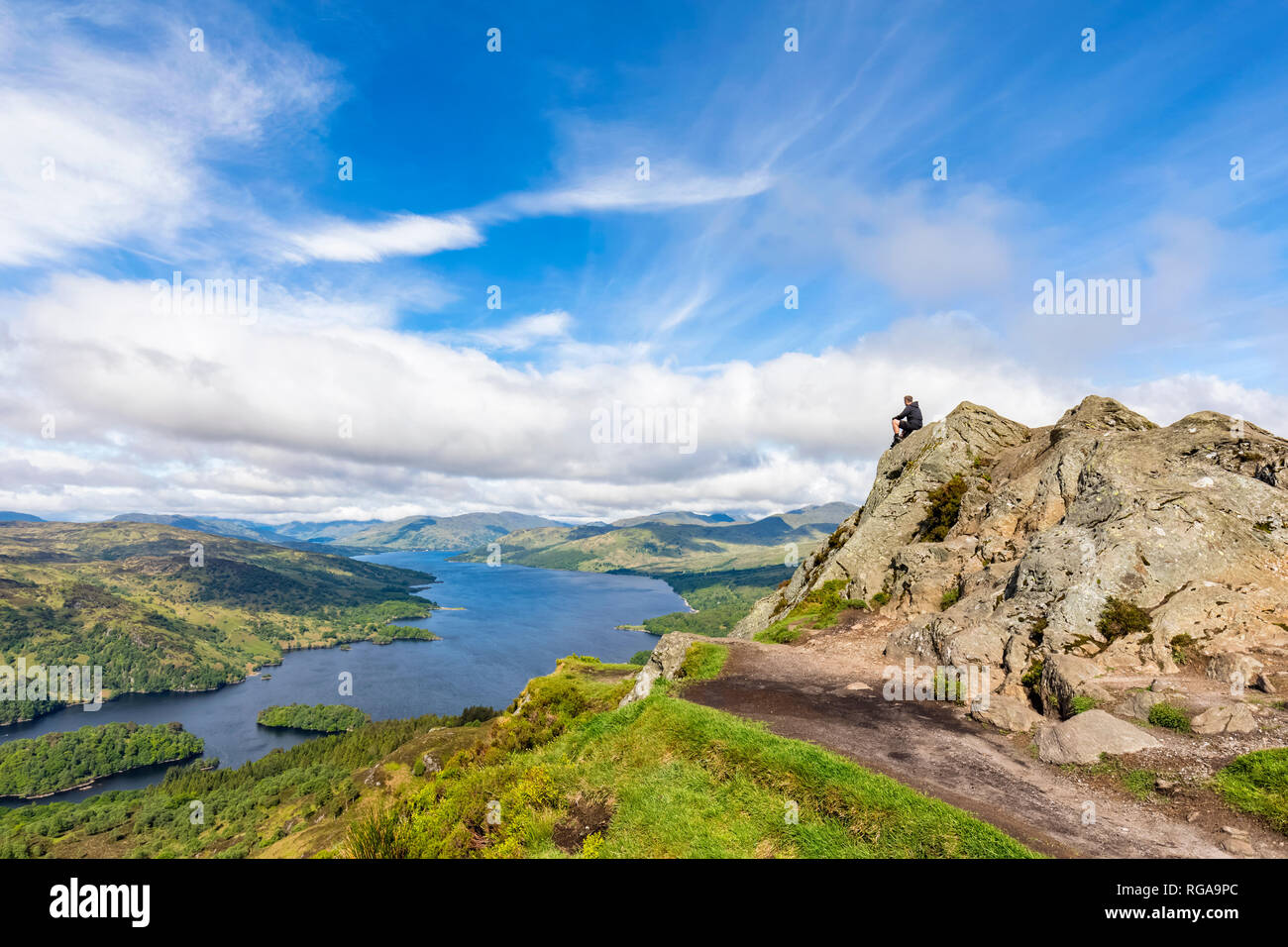 UK, Scotland, Highland, Trossachs, tourist looking from mountain Ben A'an to Loch Katrine Stock Photo
