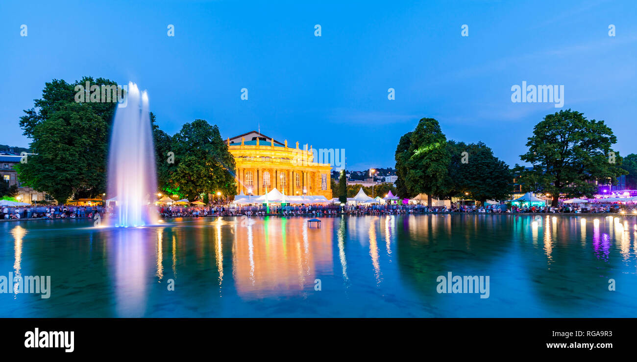 Germany, Stuttgart, palace garden, Eckensee, state theatre, opera house during summer party, blue hour Stock Photo