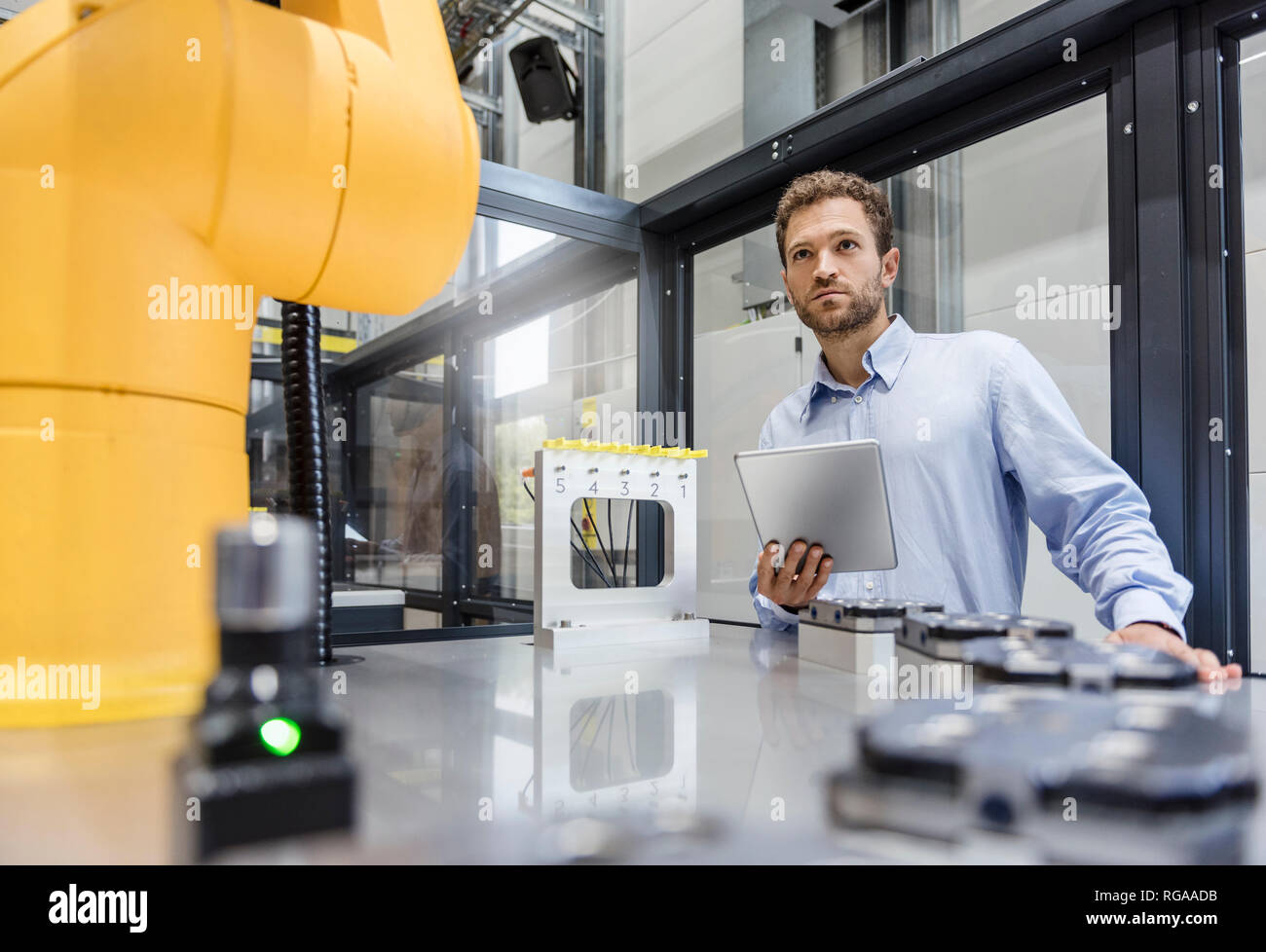 Businessman, working in a manufacturing company, using digital tablet Stock Photo