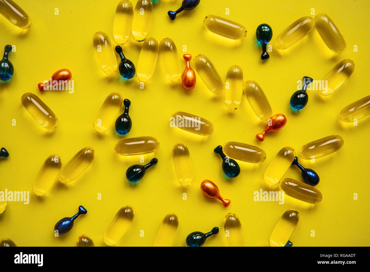 Capsule background with Omega 3, hyaluronic acid and coenzyme. Caring