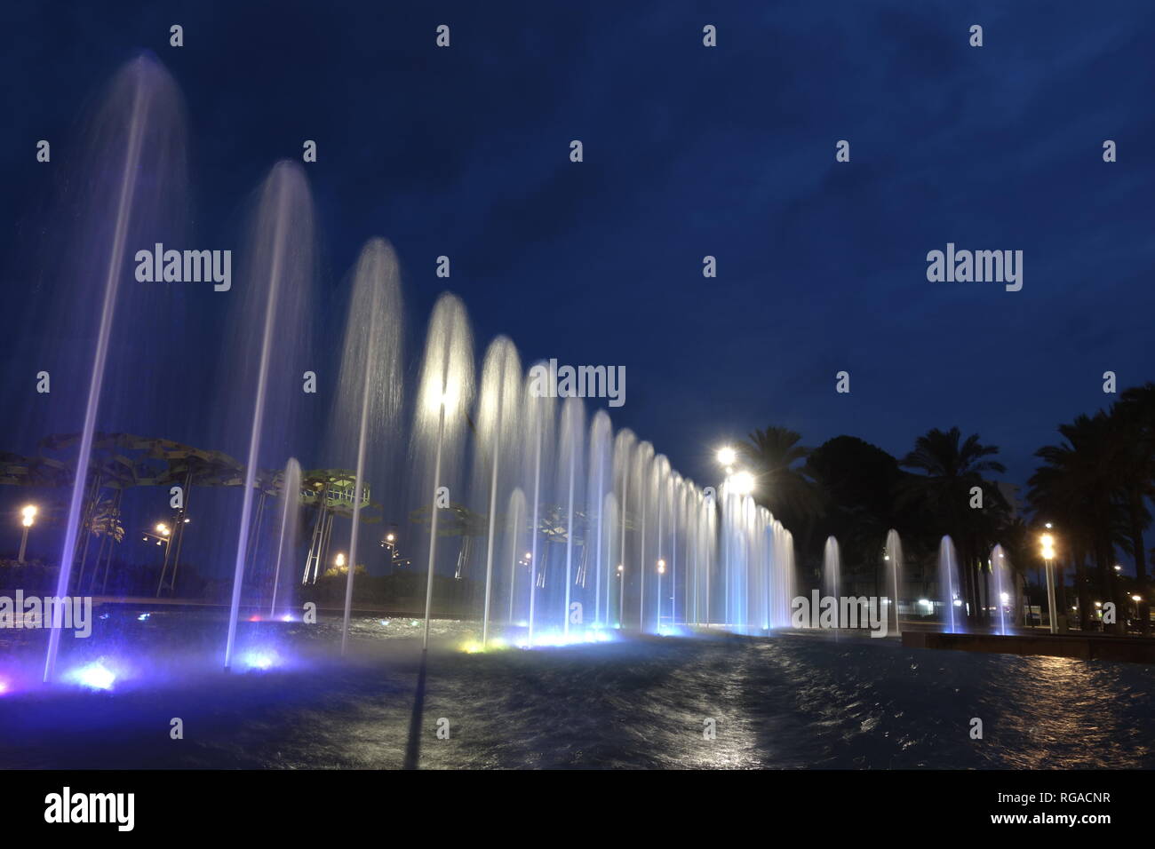 Fountain jets at night, in a long exposure shot Stock Photo