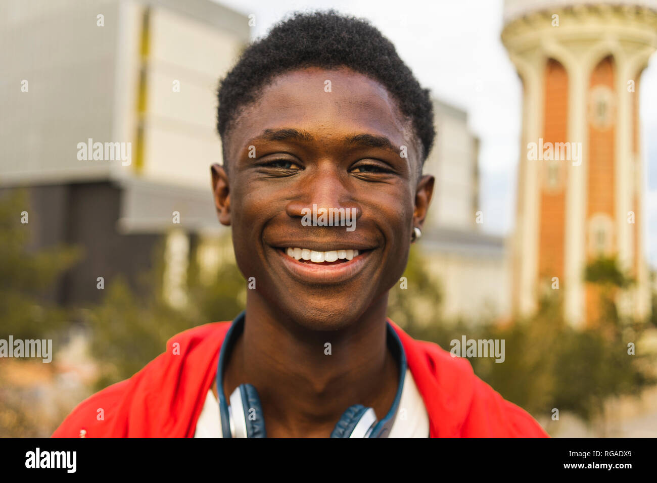 Young black man with headphones, smiling, portrait Stock Photo