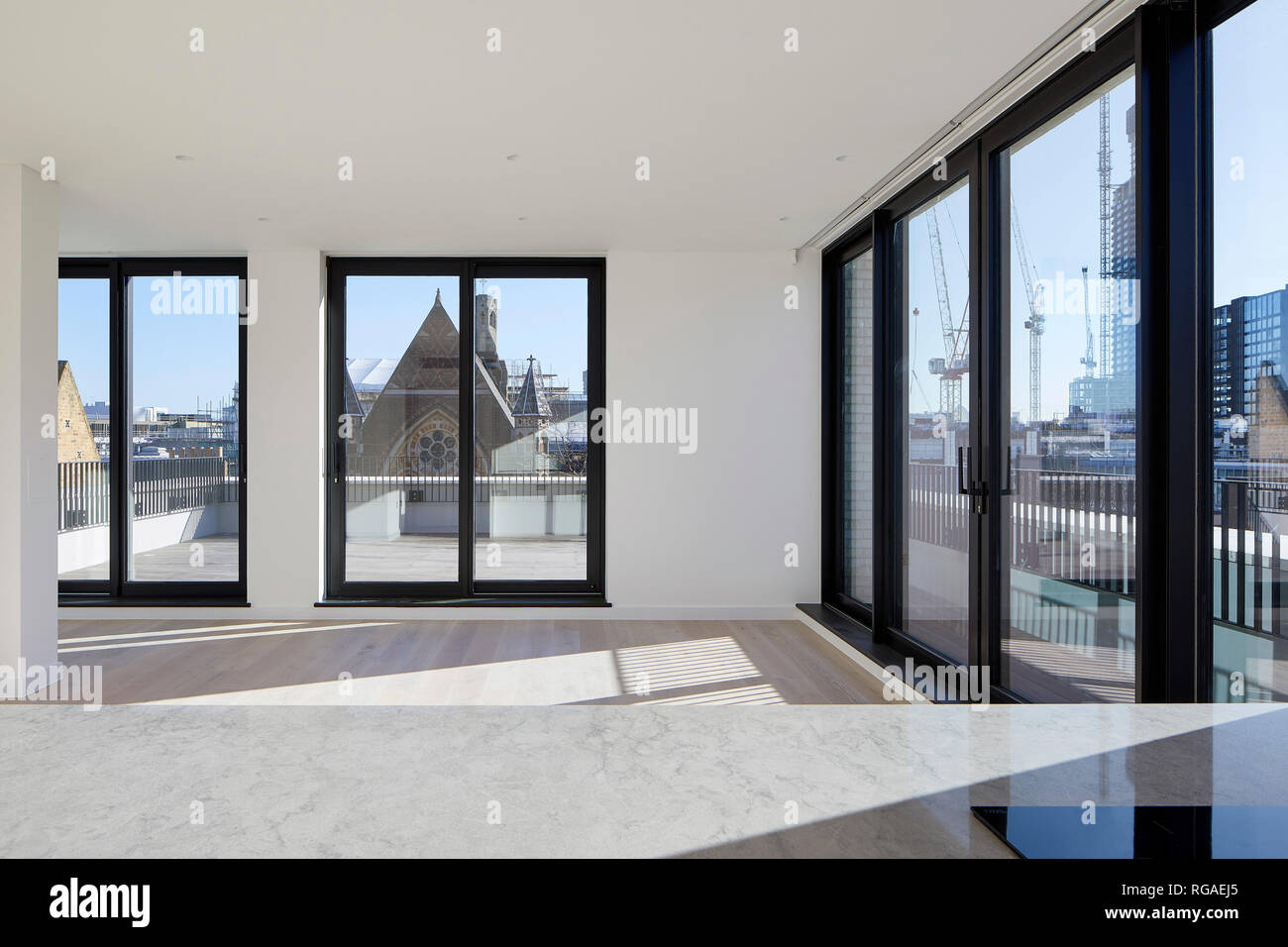 Unfurnished open plan penthouse interior. Paul Street, London, United Kingdom. Architect: Stiff + Trevillion Architects, 2018. Stock Photo