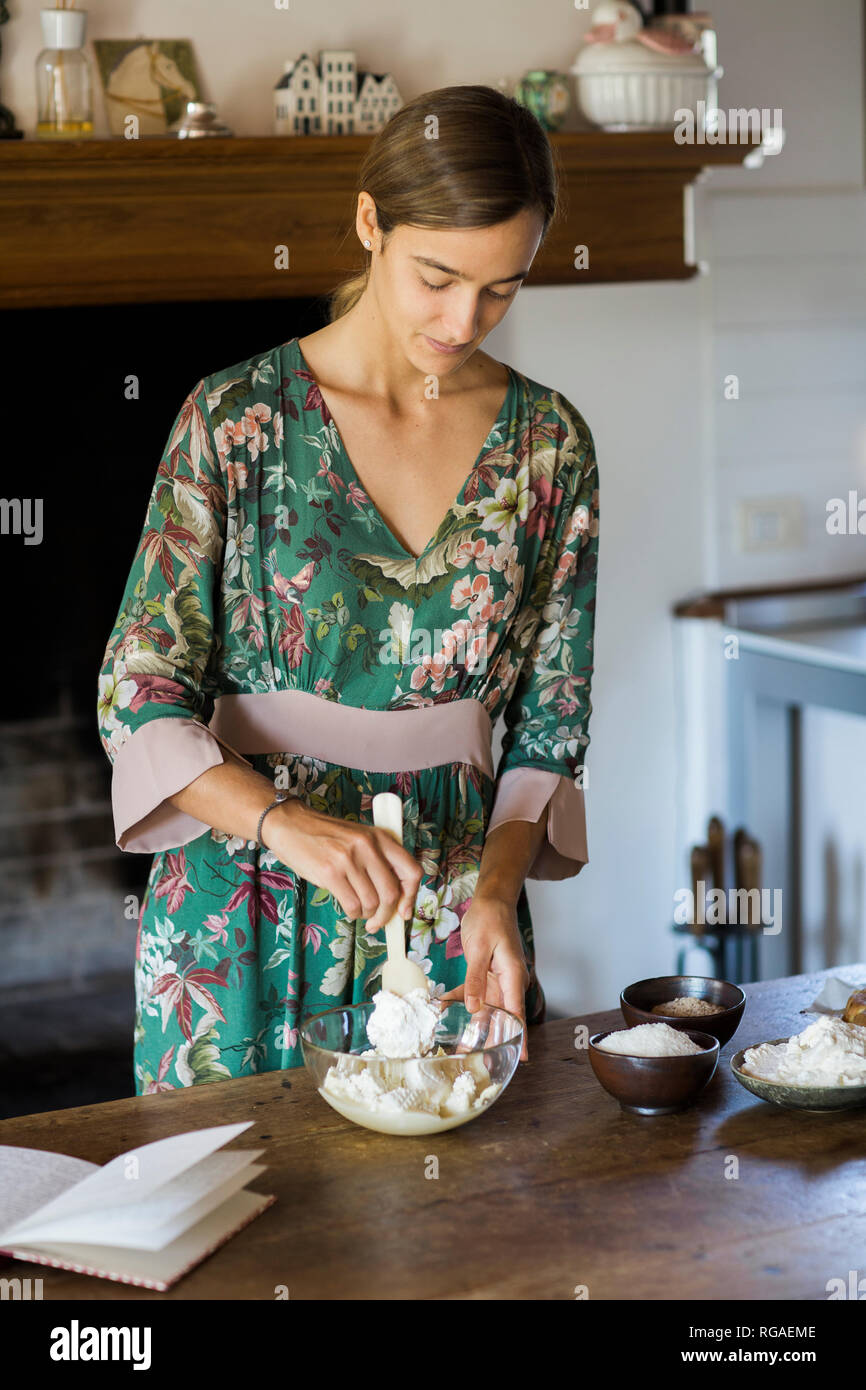 Young woman preparing cake dough Stock Photo