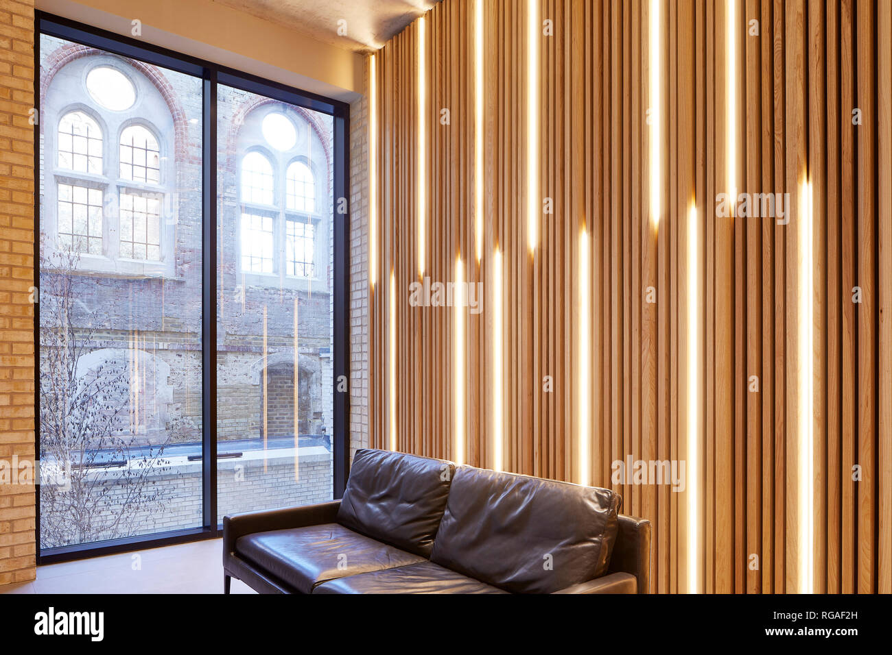 Detail of backlit timber panelling in ground floor lounge with picture window. Paul Street, London, United Kingdom. Architect: Stiff + Trevillion Arch Stock Photo