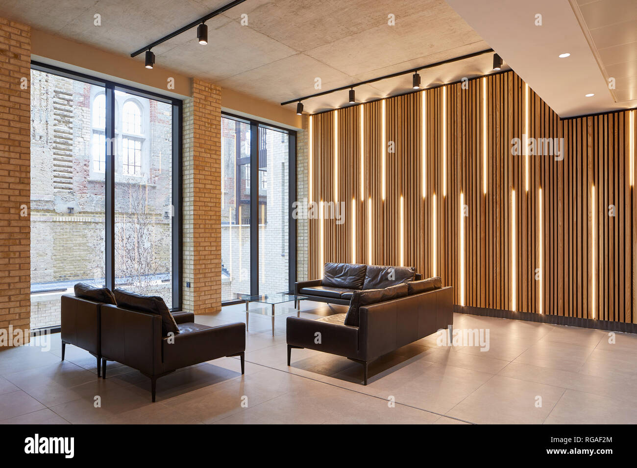 Backlit timber panelling in ground floor lounge. Paul Street, London, United Kingdom. Architect: Stiff + Trevillion Architects, 2018. Stock Photo