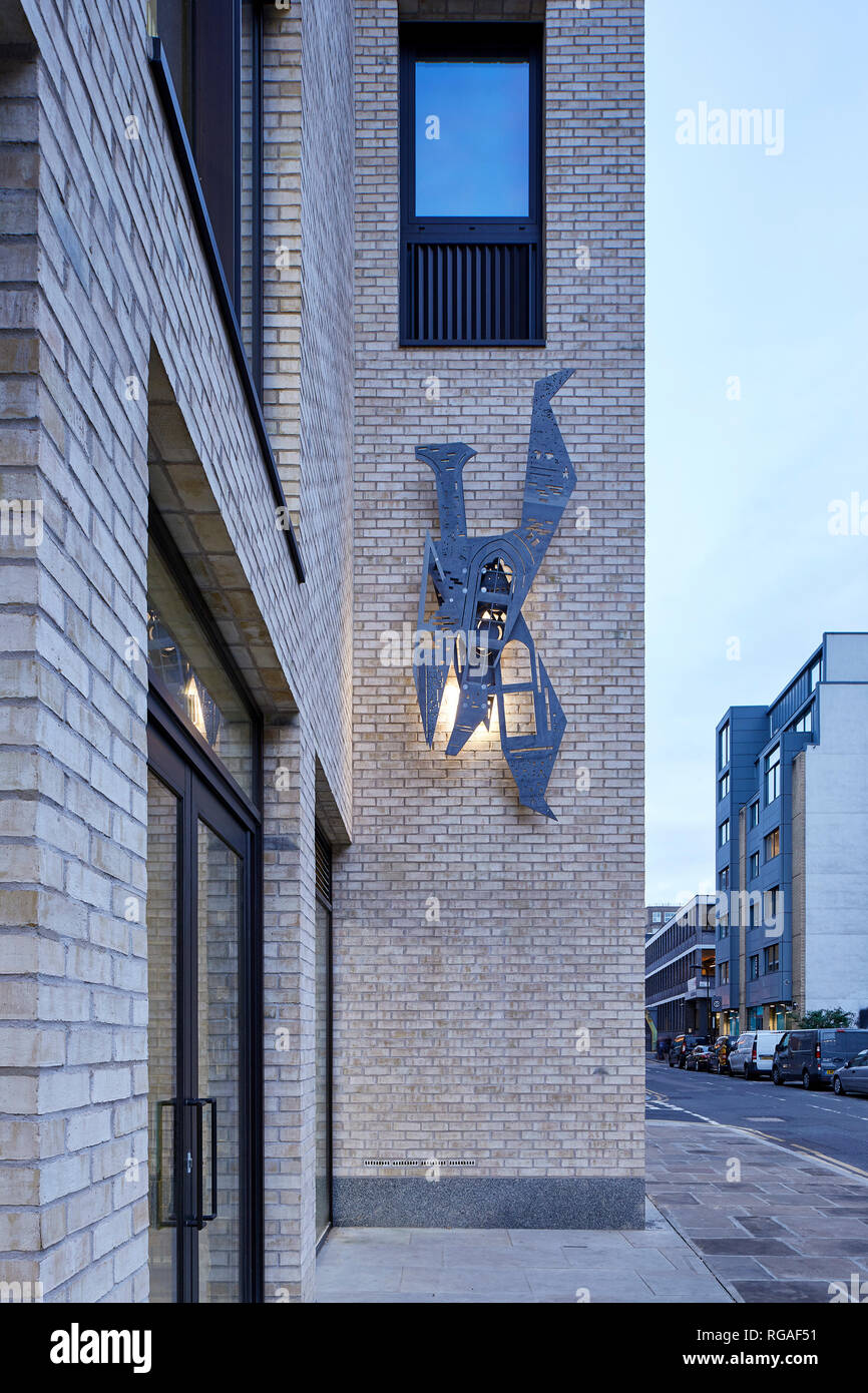 Brick detail with facade-mounted wall sculpture. Paul Street, London, United Kingdom. Architect: Stiff + Trevillion Architects, 2018. Stock Photo