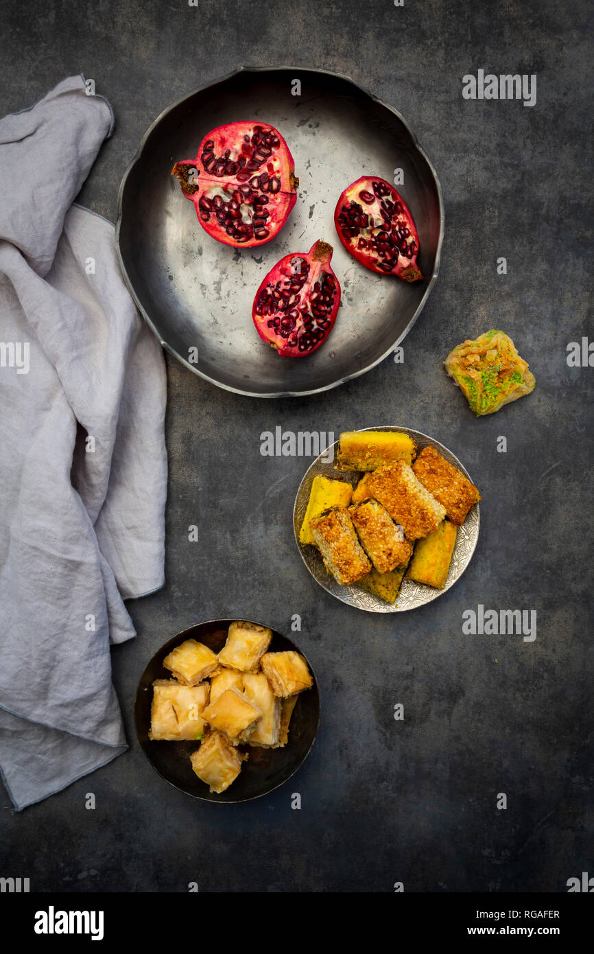 Baklava, Shamiat and pomegranate in bowls, from above Stock Photo