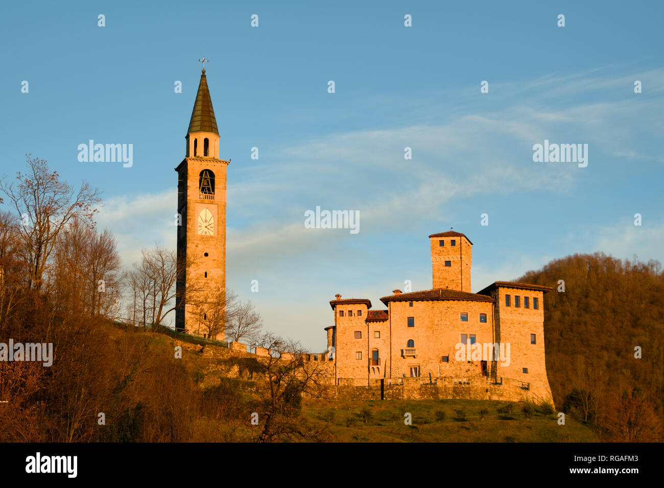 Bell tower and Savorgnan Castle during the sunset in Artegna, Friuli, Italy Stock Photo