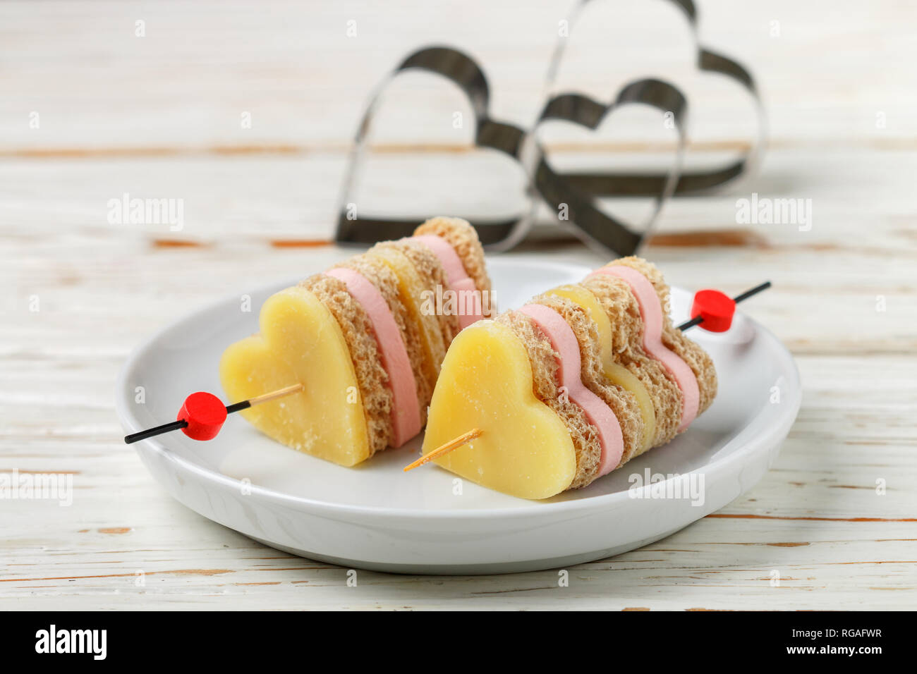 Mini sandwiches parmesan cheese ham bread on skewers in the form of hearts.  Valentine's day. Breakfast for loved ones. Selective focus and copy space  Stock Photo - Alamy
