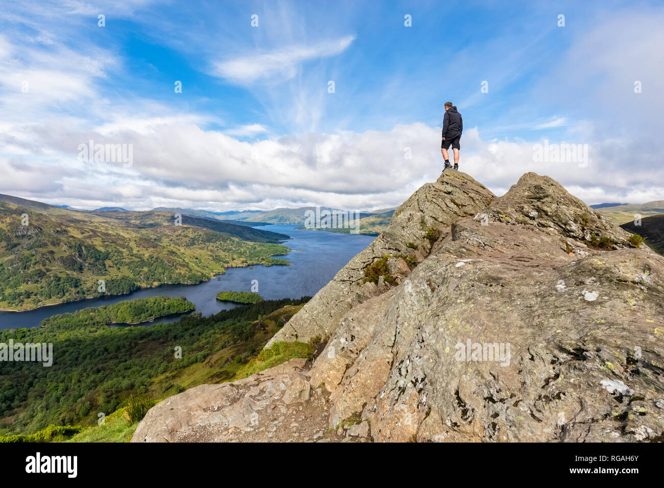 UK, Scotland, Highland, Trossachs, tourist looking from mountain Ben A'an to Loch Katrine Stock Photo