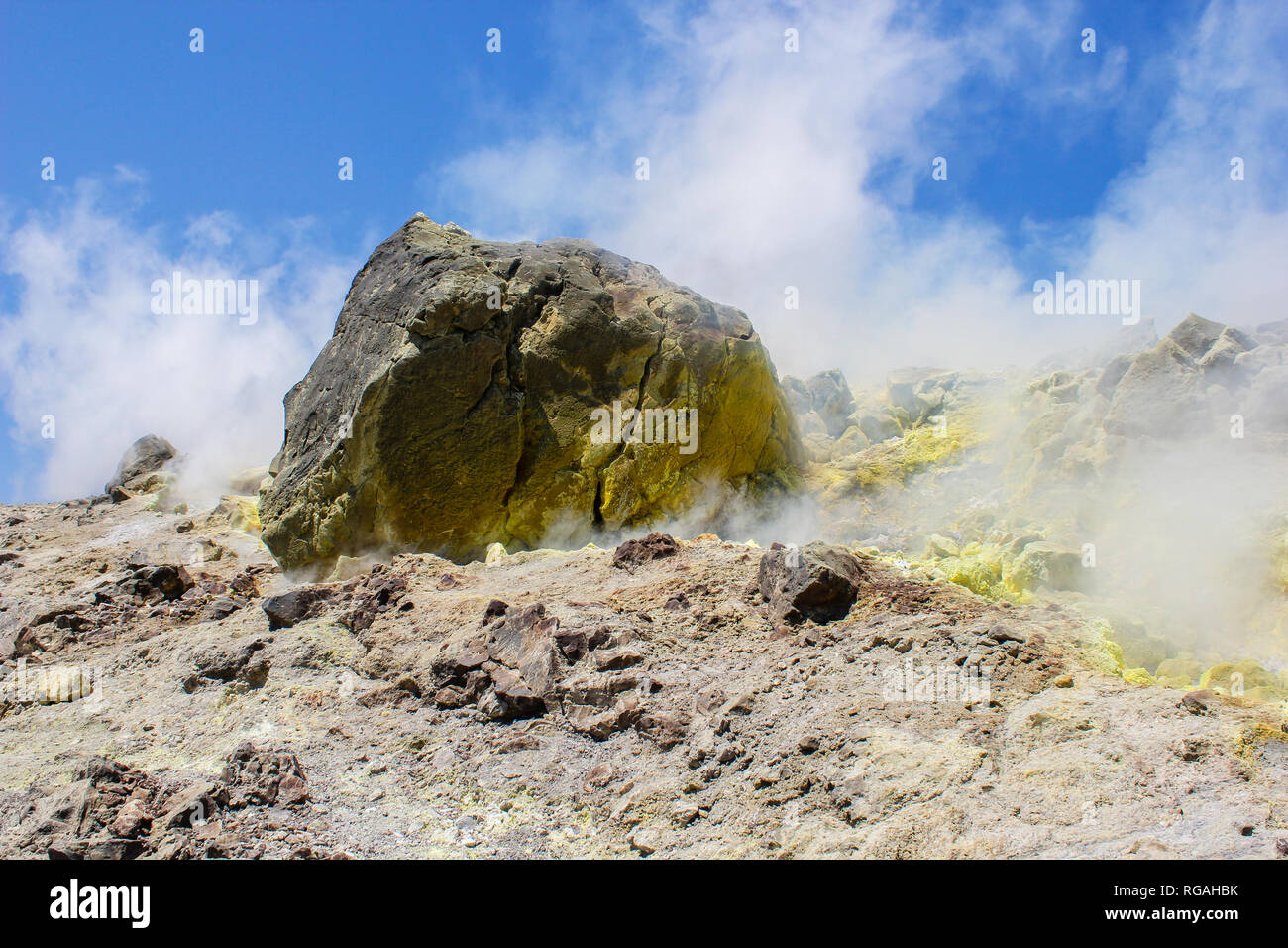 Steam of a volcanic spring with yellow sulphur, creating a very bad rotten egg smell in the landscape of Vulcano, an Aeolian island in Italy Stock Photo