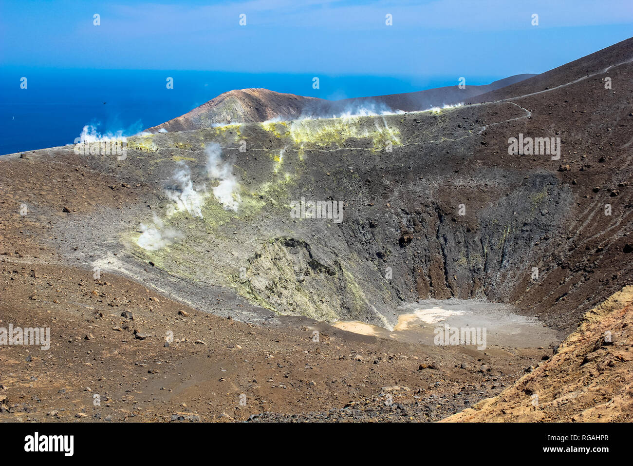 The crater of a volcano at Vulcano Island in Italy attracts tourists with the steams of sulphur. Stock Photo