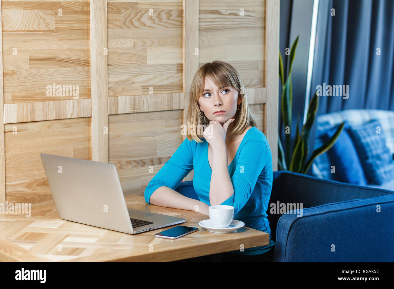 Beautiful Thinkful Young Girl Freelancer With Blonde Bob Haircut