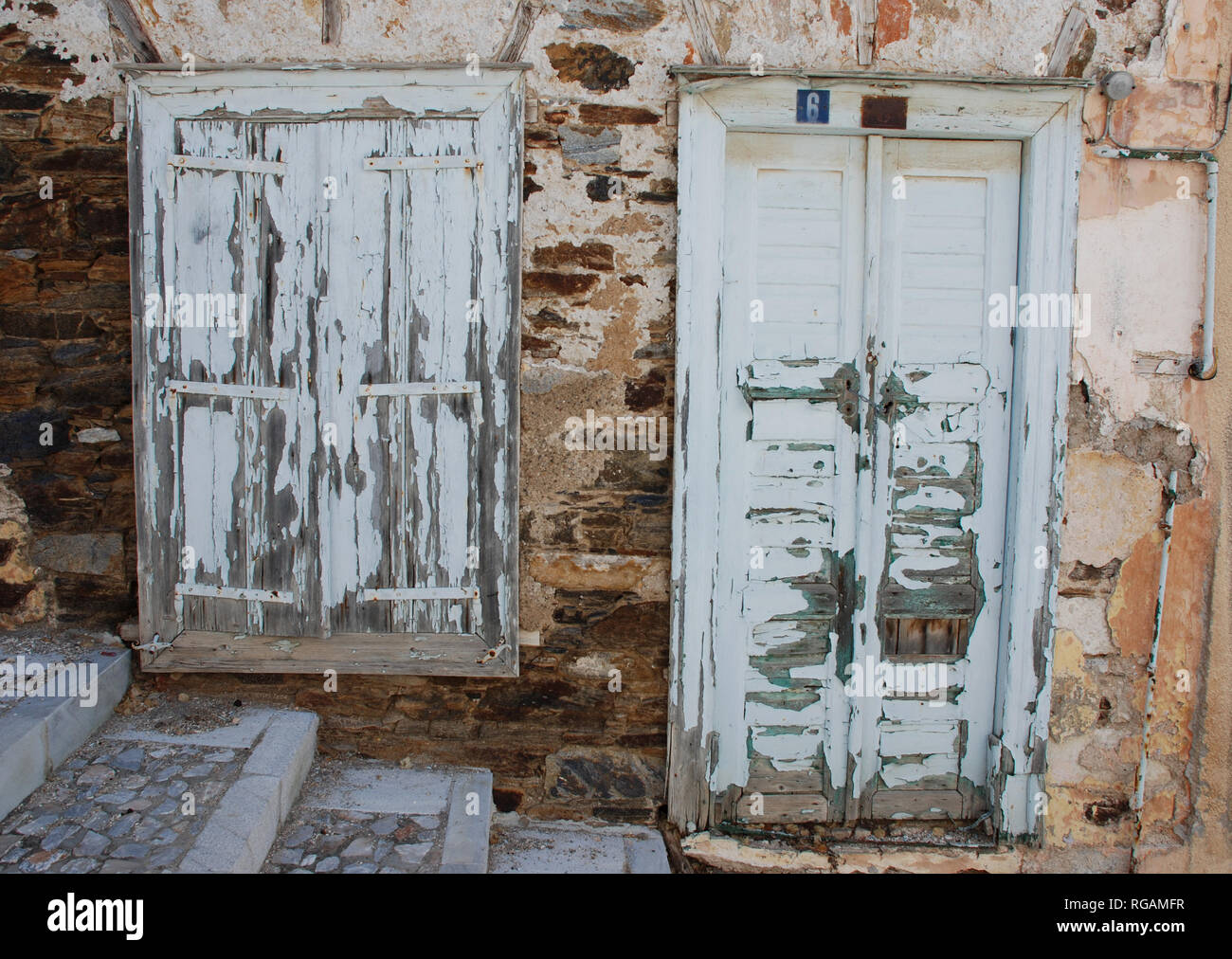 Front door and window on hillside home on Syros, Greece Stock Photo