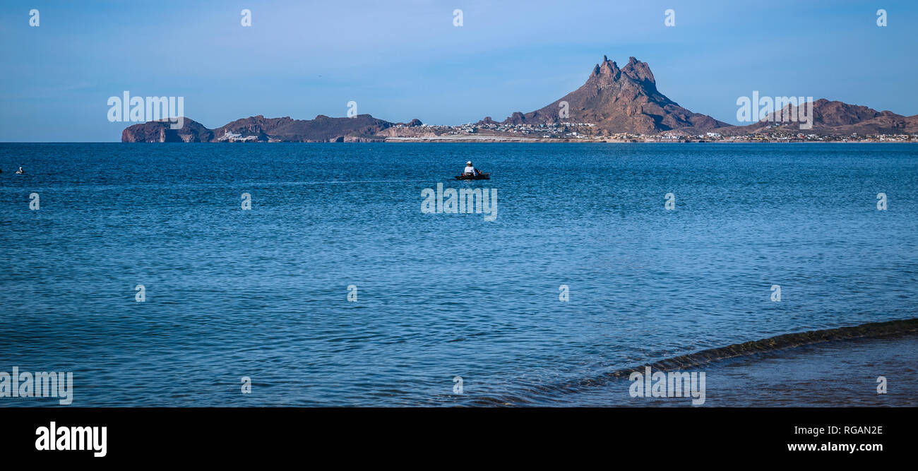 Beautiful Mount Tetakawi is the backdrop for a pedal boater in the Bahia Peninsula, Mexico's Pacific Northwest coast. Stock Photo