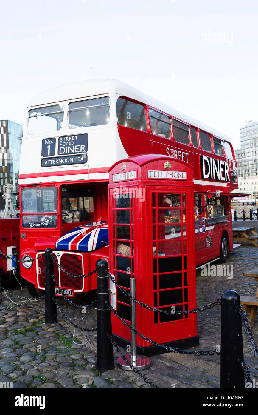 The Street Food Diner at the Royal Albert Dock in Liverpool, England. The double decker bus stands next to British K6 telephone box. Stock Photo
