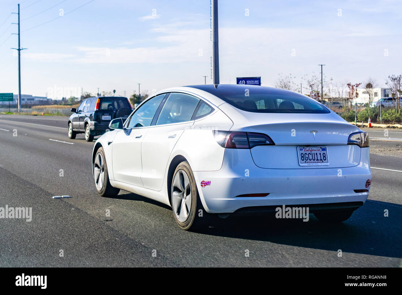 January 27, 2019 Santa Clara / CA / USA - White Tesla Model 3 driving on the freeway in Silicon Valley, south San Francisco bay area Stock Photo