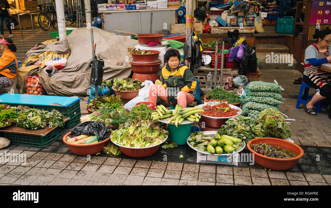 Local Korean female farmers selling fresh produce at a street market in
