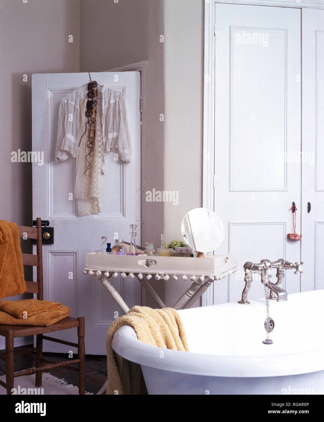 Painted tray table beside roll top bath in grey bathroom Stock Photo ...