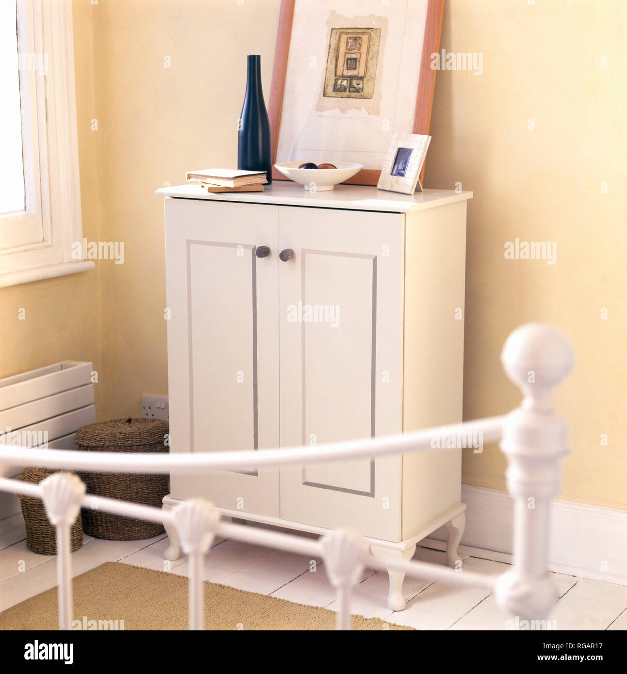 Small freestanding cupboard painted cream Stock Photo Alamy