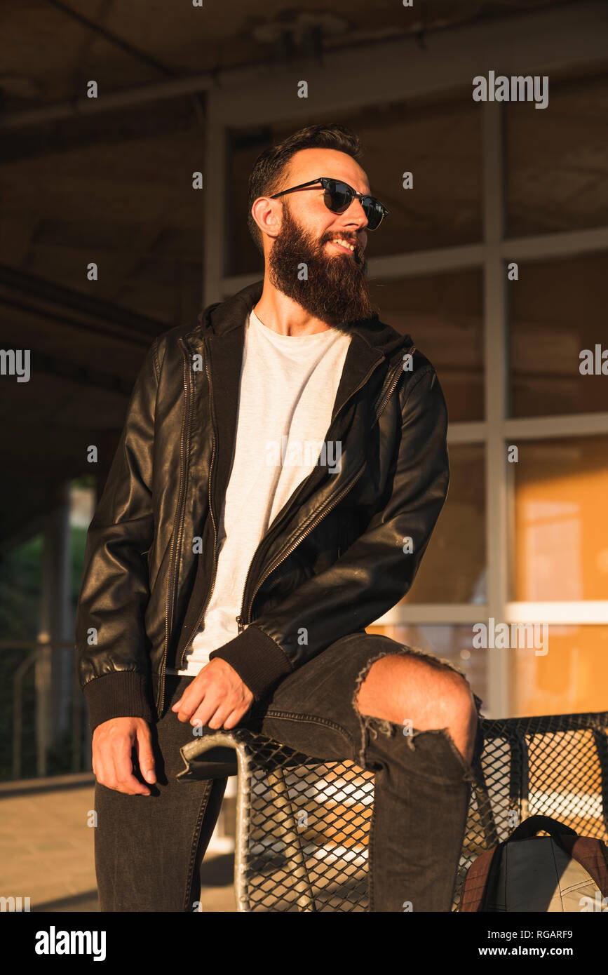 Stylish bearded young man outdoors looking sideways Stock Photo