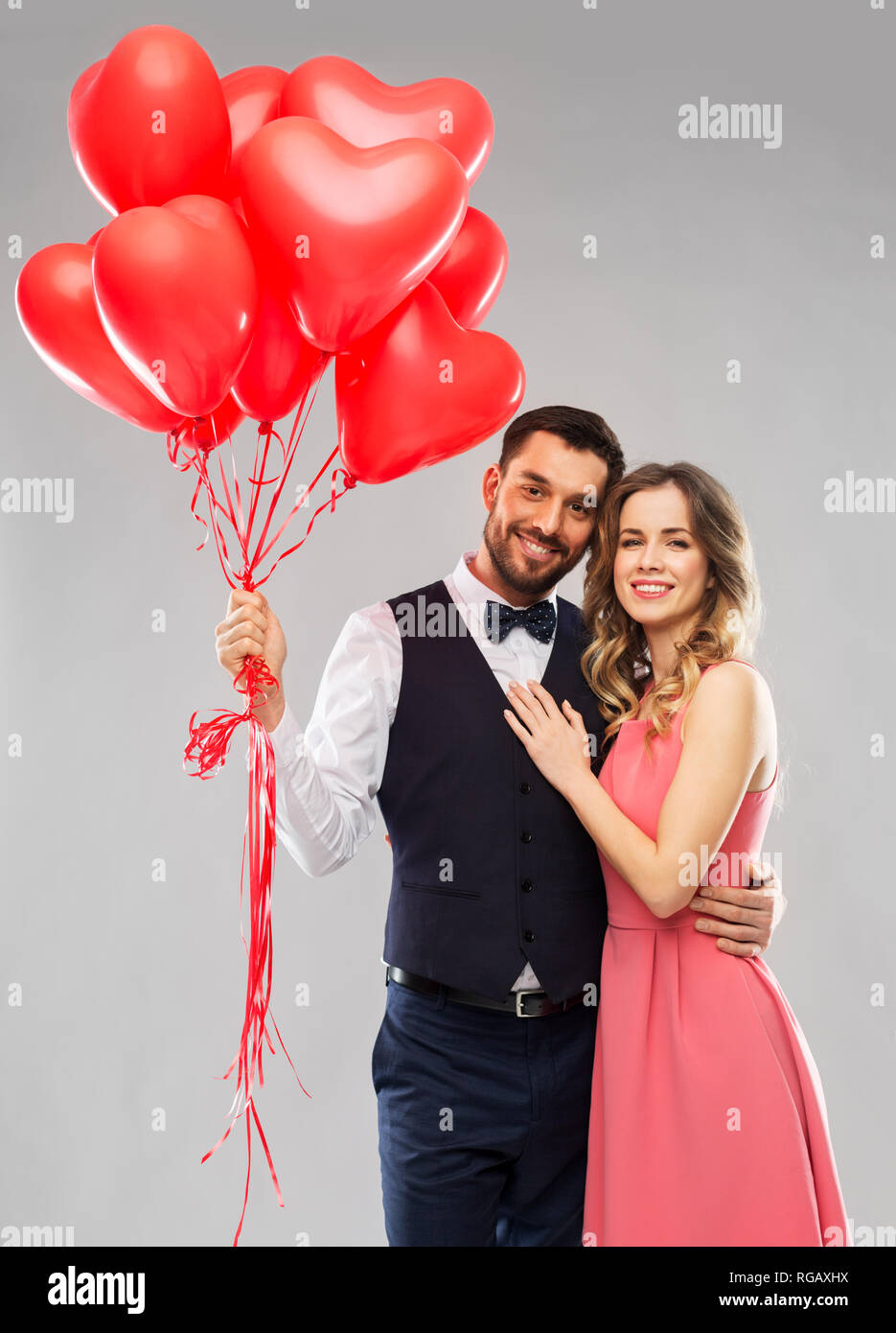happy couple with red heart shaped balloons Stock Photo - Alamy