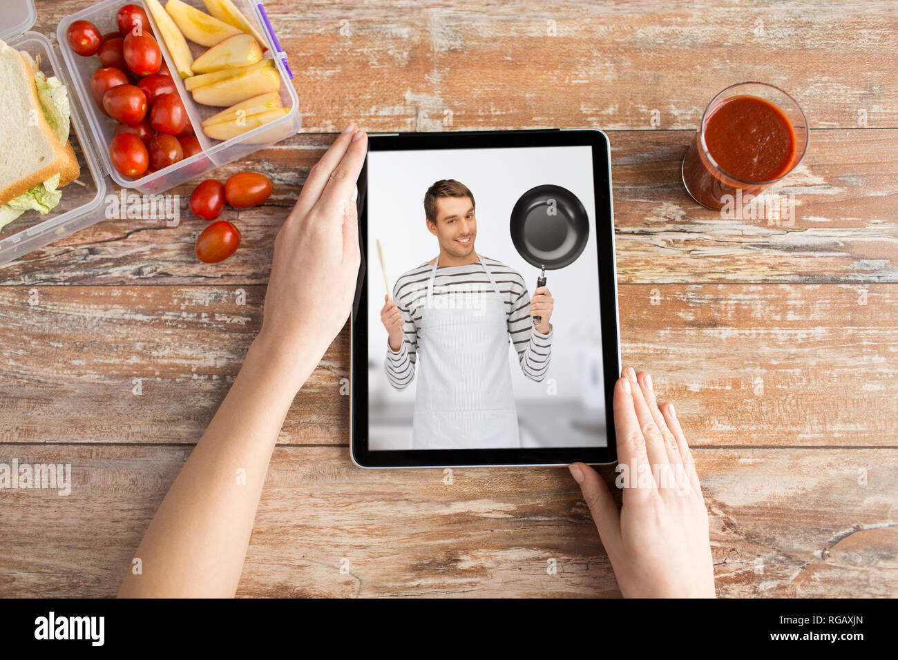 woman watching cooking video on tablet computer Stock Photo