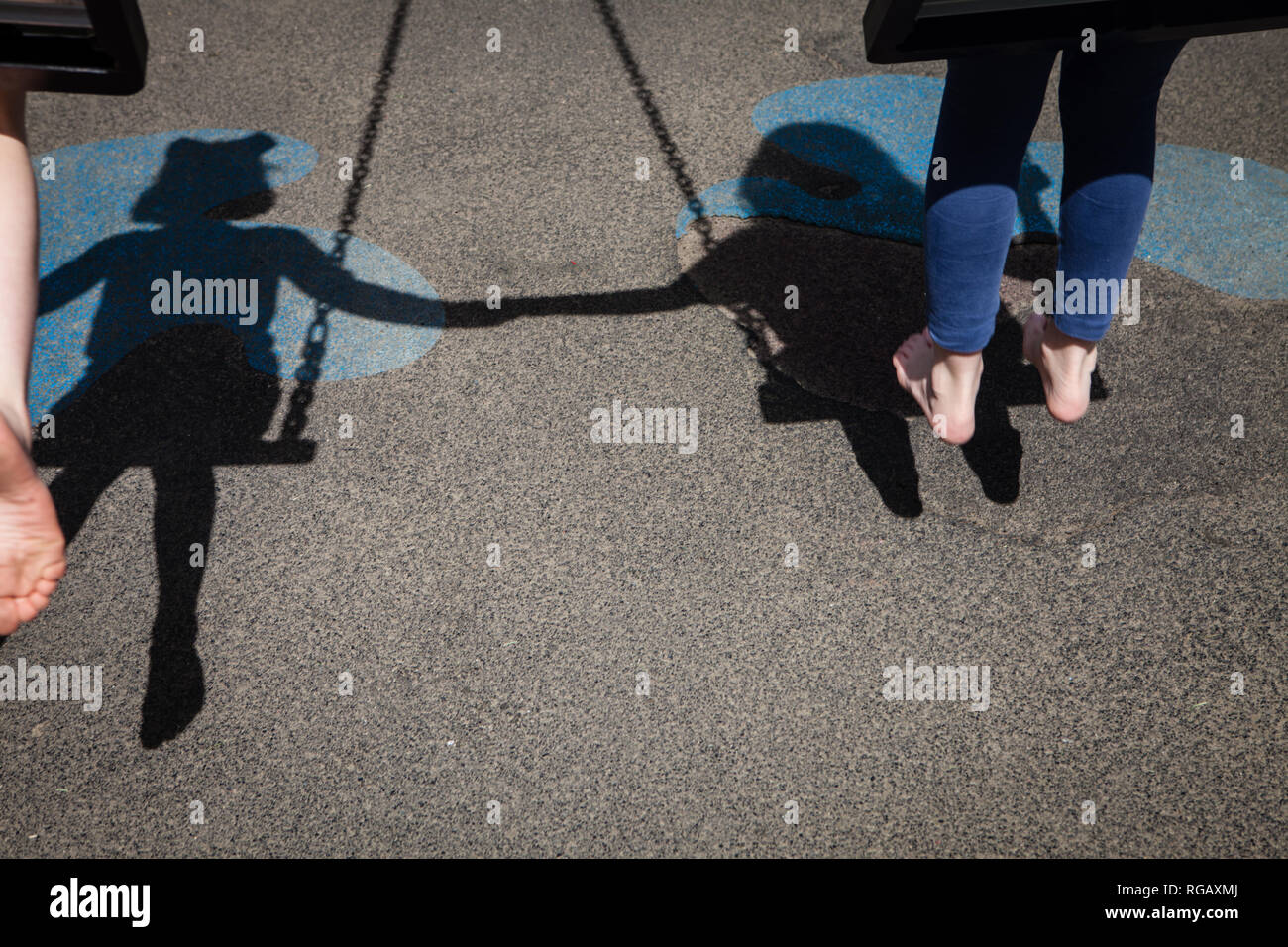 Two girls swings rear view hi-res stock photography and images - Alamy