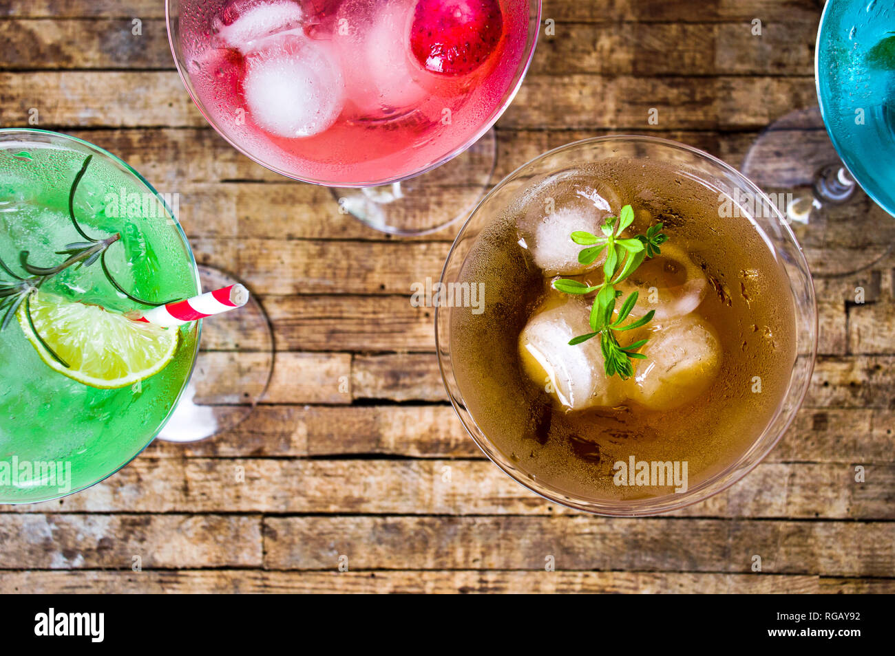 Colorful cocktails on a wooden table top view Stock Photo