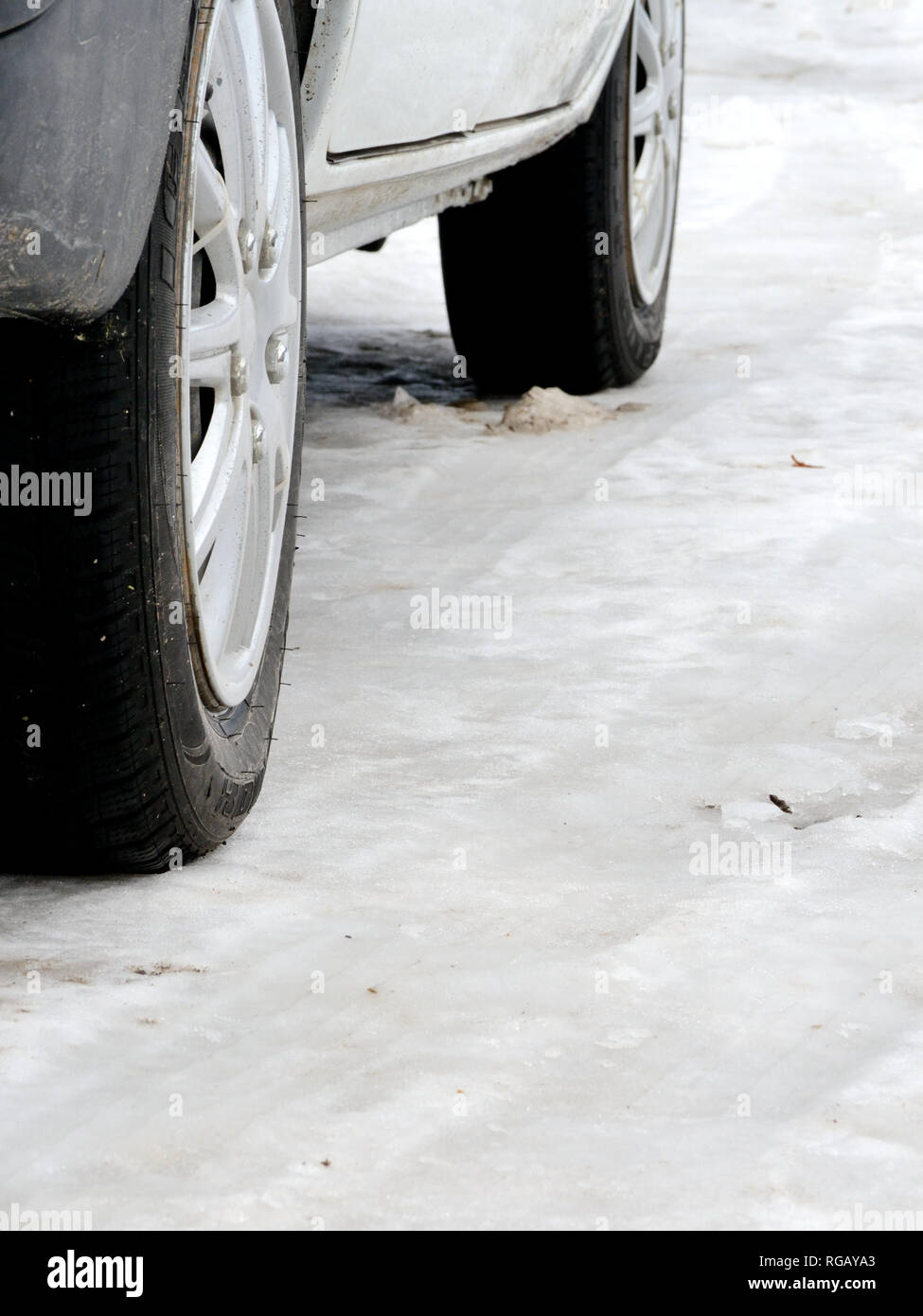 Winter car tires on winter road Stock Photo