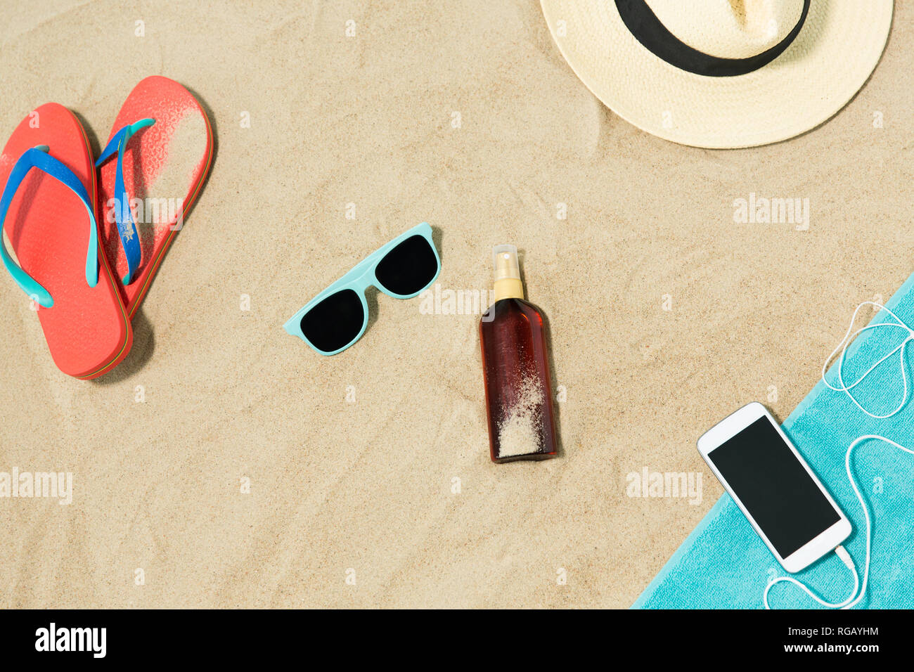 smartphone, hat, flip flops and shades on beach Stock Photo - Alamy