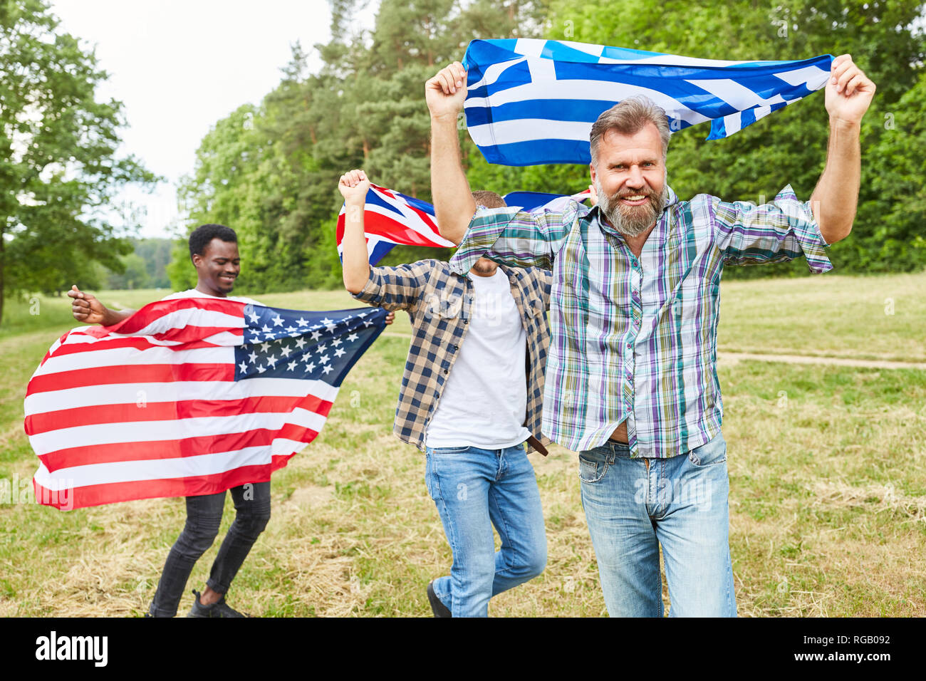 Young people run proudly with their national flags as a symbol of patriotism Stock Photo
