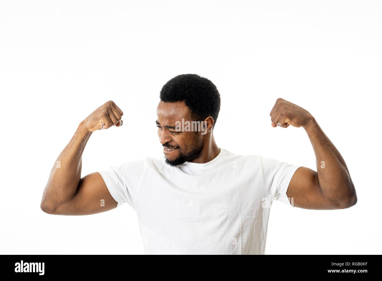 Young strong handsome african american man showing arms muscles smiling proud having fun in people, Happiness, Fitness, success Human emotions and fac Stock Photo