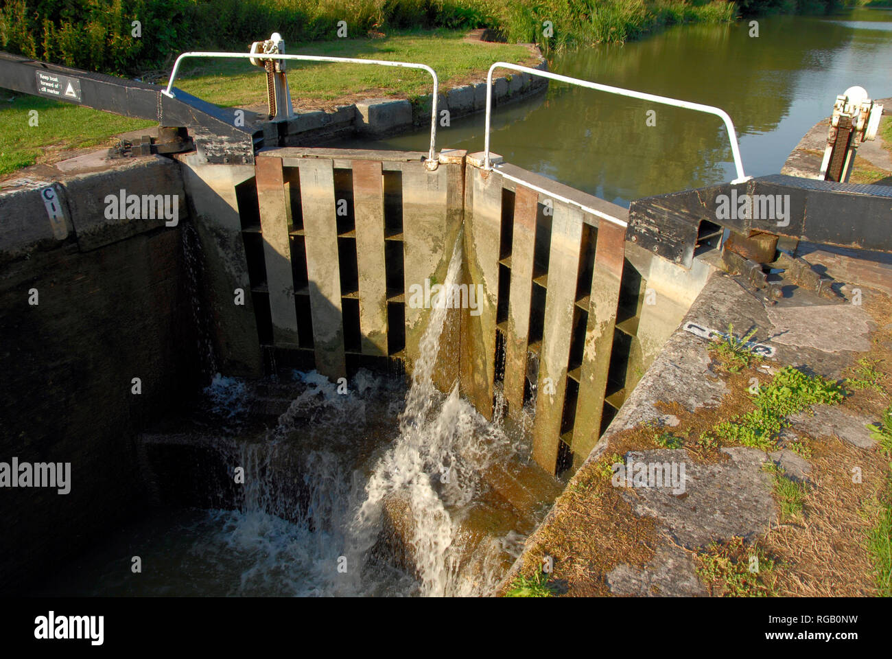 Water gushing through lock gates on Kennet & Avon canal, Wiltshire, England Stock Photo