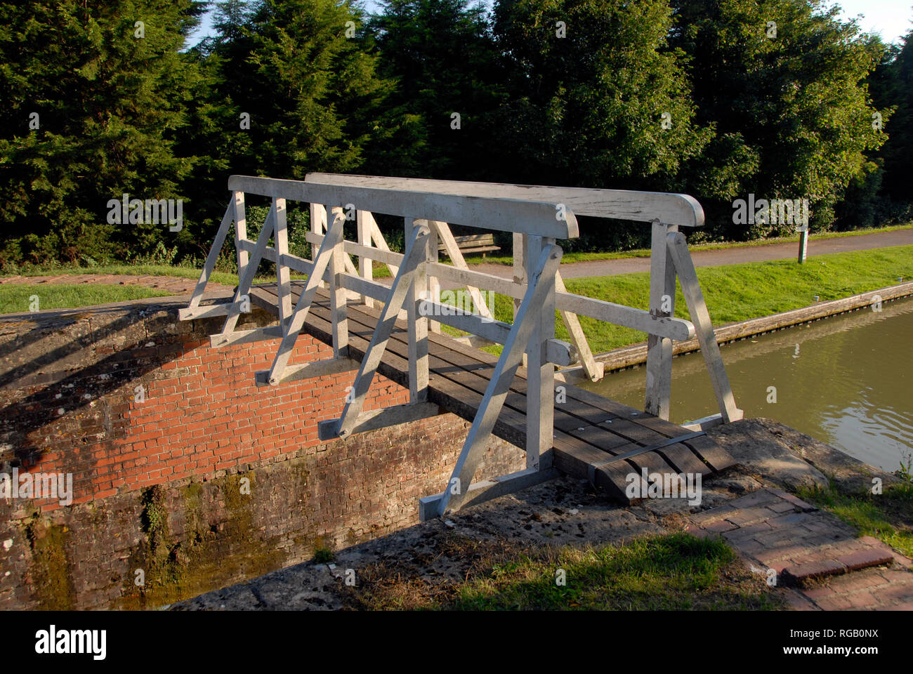 Lock on Kennet & Avon canal, Wiltshire, England, with bridge to cross from side to side. Stock Photo