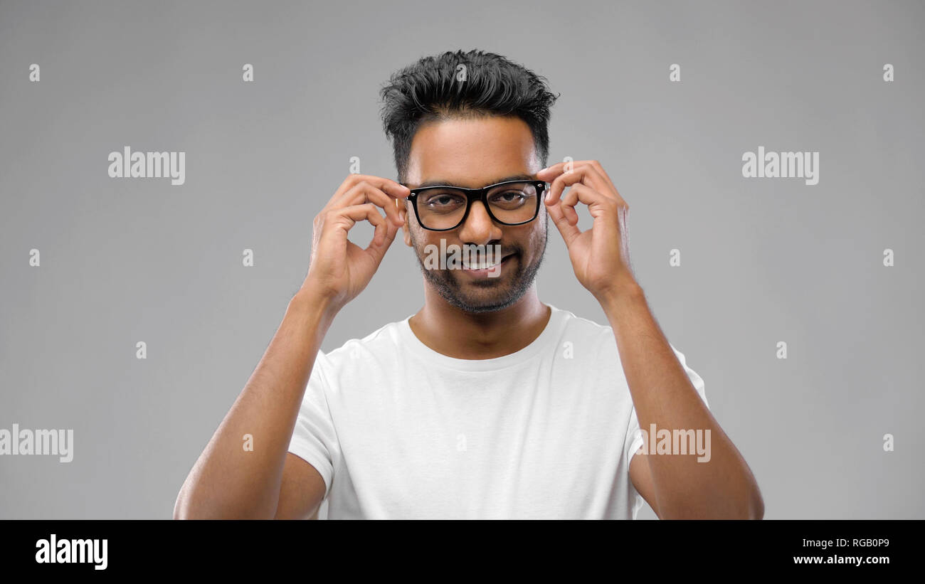 happy indian man in eyeglasses or student Stock Photo