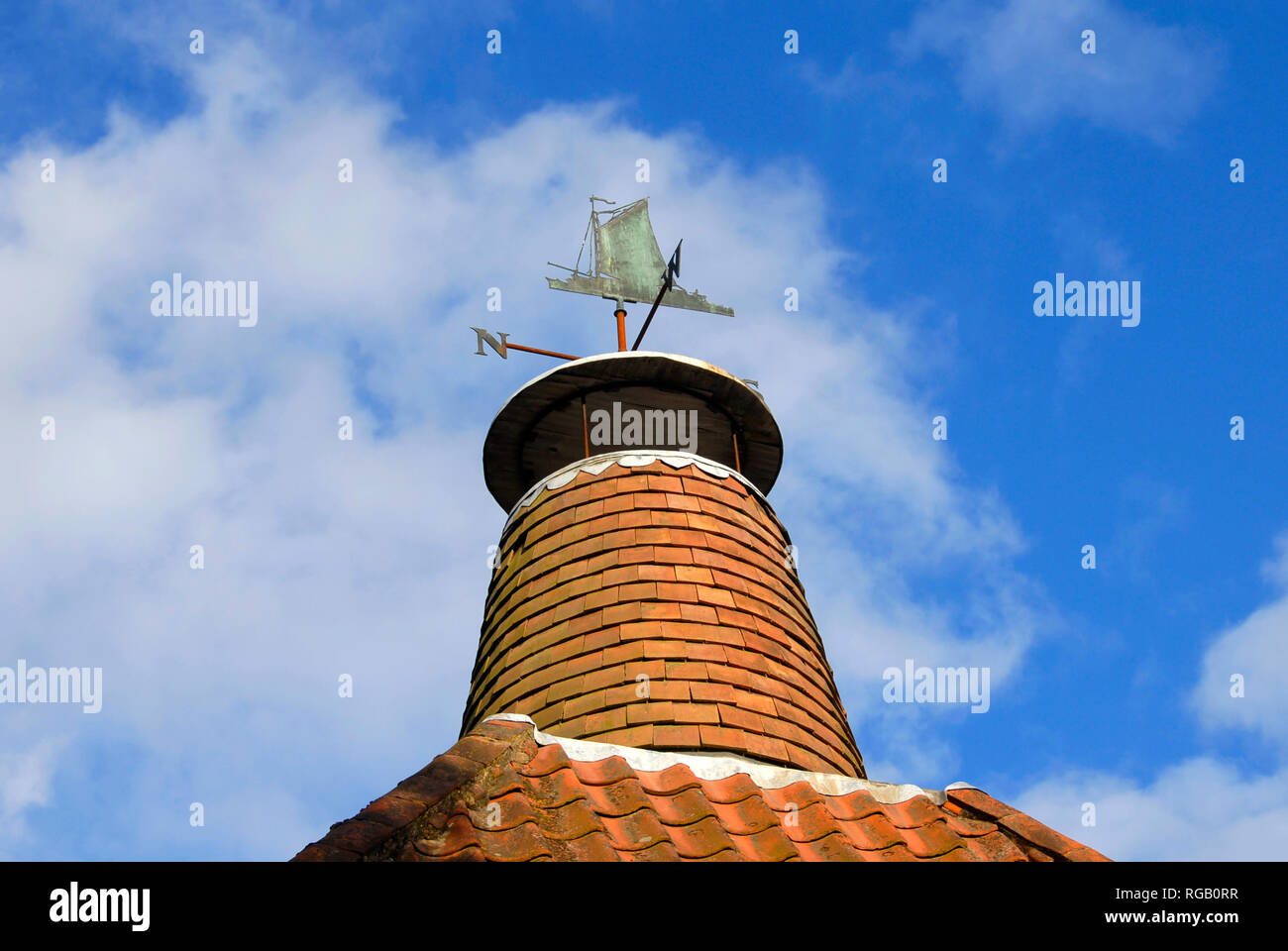Chimney with weather vane on top in form of Norfolk wherry, Ludham, Norfolk, England Stock Photo