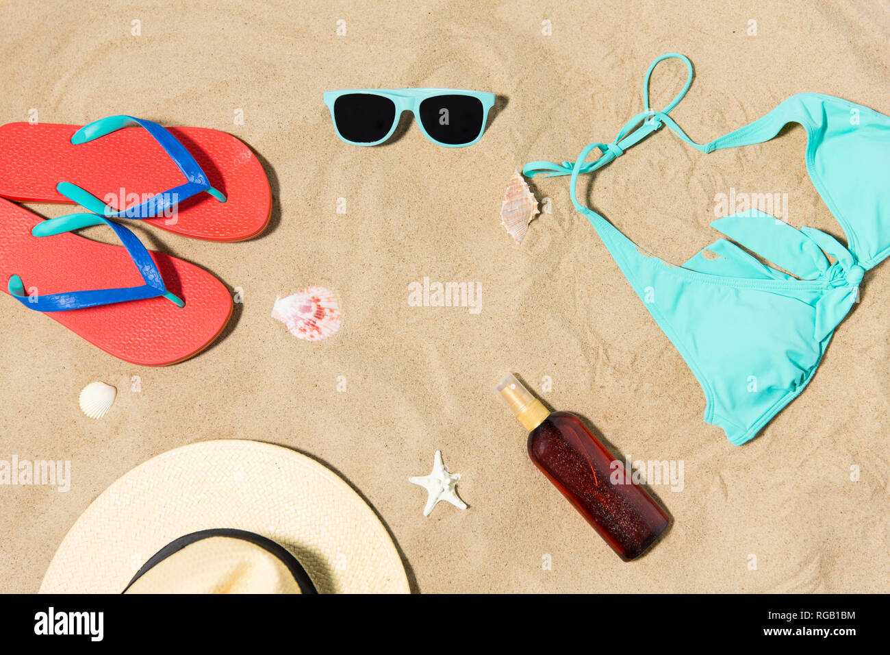 straw hat, flip flops and sunglasses on beach sand Stock Photo - Alamy