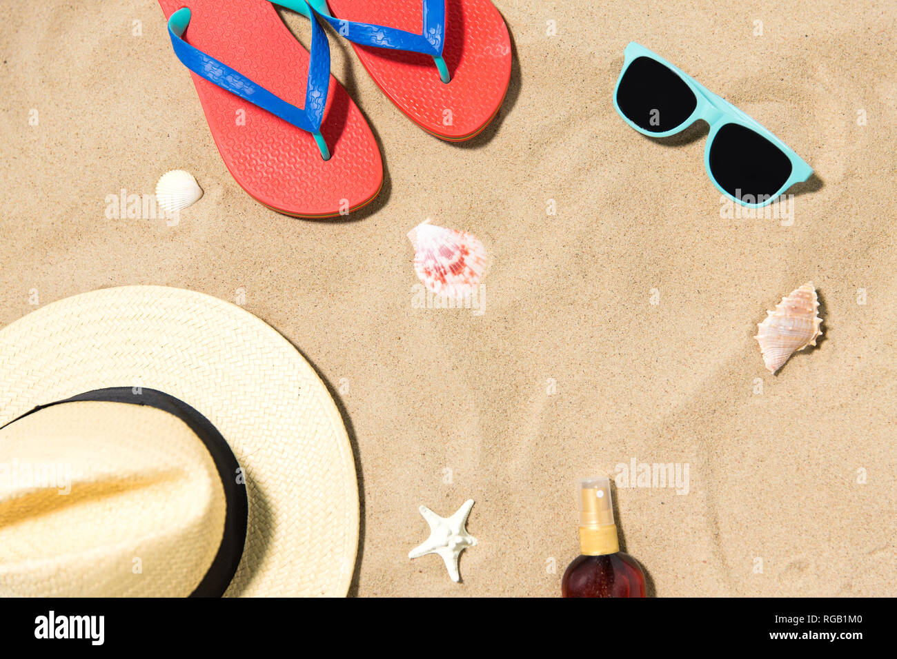 straw hat, flip flops and sunglasses on beach sand Stock Photo - Alamy