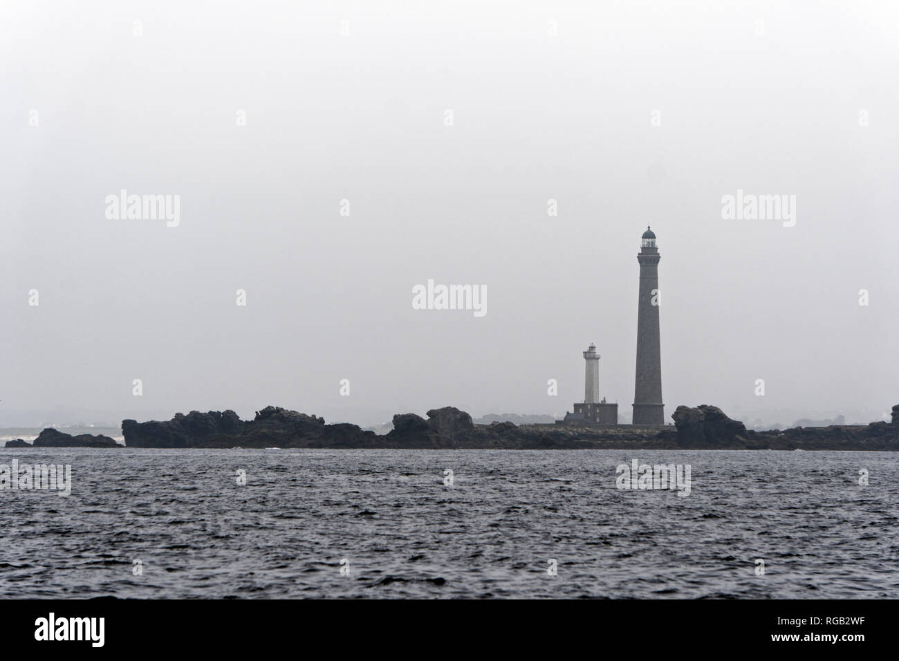 Ile Vierge lighthouse, the tallest in Brittany; France on a misty day. Photographed from the sea. Stock Photo