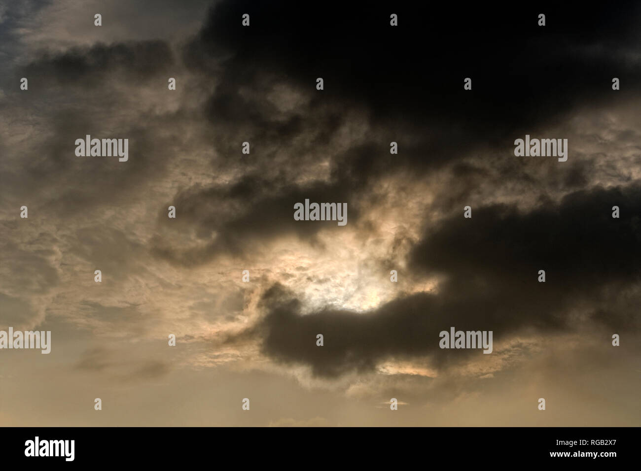 Dark clouds covering the sun Stock Photo