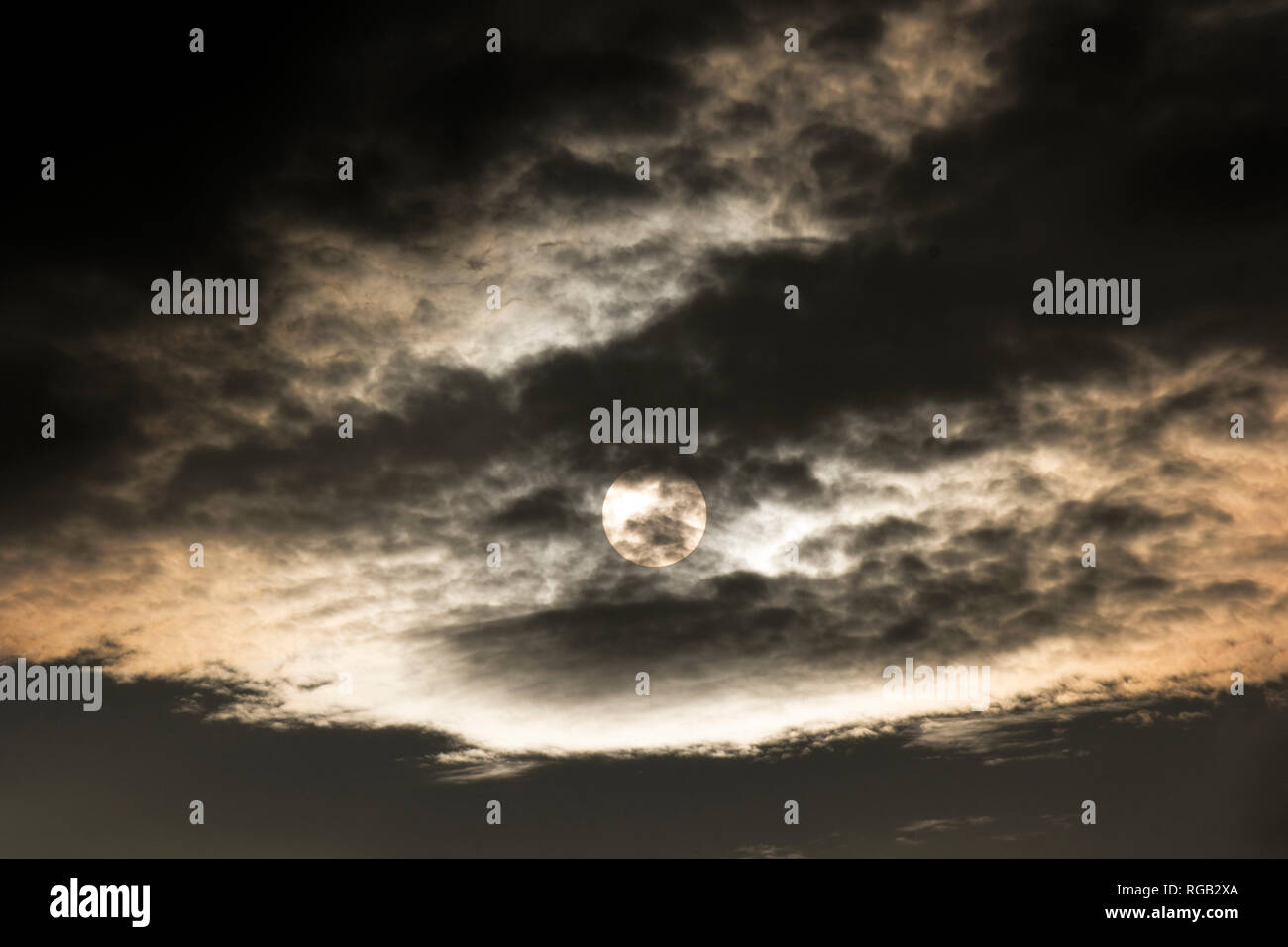 Dark clouds covering the sun Stock Photo